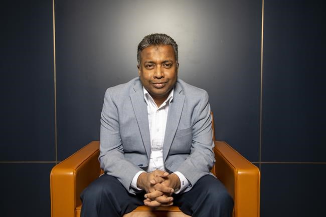 Edward Rajaratnam, executive director at Ernst & Young, poses for a photograph in the Toronto office on Wednesday, February 23, 2021. THE CANADIAN PRESS/Carlos Osorio