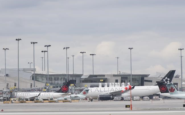 Air Canada planes are shown on the tarmac at Montreal-Pierre Elliott Trudeau International Airport, Saturday, May 16, 2020. Sky Regional Airlines Inc. will shut down at the end of March after losing its contract with Air Canada. THE CANADIAN PRESS/Graham Hughes