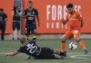 Antigua FC's Pablo Ignorance (25) slides to tackle Hamilton Forge FC's Tristan Borges (19) during first-half Scotiabank CONCACAF League soccer action in Hamilton, Ont., Thursday, Aug. 1, 2019. Borges, a former player of the year in the Canadian Premier League, is returning to Forge FC. THE CANADIAN PRESS/Peter Power