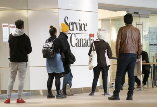 People line up at a Service Canada office in Montreal on Thursday, March 19, 2020. Statistics Canada to detail February jobs dataStatistics Canada will say today how the country's job market fared in February after it started 2021 with a steep drop. THE CANADIAN PRESS/Paul Chiasson