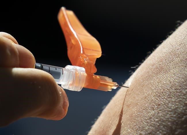 A dose of the Pfizer-BioNTech COVID-19 vaccine is given to a recipient at a vaccination site in Vancouver on Thursday, March 11, 2021. THE CANADIAN PRESS/Jonathan Hayward