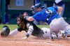 Pittsburgh Pirates' Rodolfo Castro (64) scores under the tag of Toronto Blue Jays catcher Danny Jansen during the fifth inning of a spring training exhibition baseball game at LECOM Park in Bradenton, Fla., Friday, March 12, 2021. THE CANADIAN PRESS/AP-Gene J. Puskar