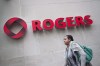 A pedestrian walks past the Rogers Building in Toronto on April 22, 2014. Some experts say Rogers Communications Inc.'s proposed deal to buy Shaw Communications Inc. is raising questions about how far regulators and elected politicians will go to encourage competitive pricing in the Canadian telecom industry. THE CANADIAN PRESS/Darren Calabrese