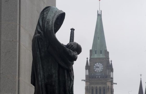 The statue representing justice looks out from the Supreme Court of Canada over the Parliamentary precinct in Ottawa, Thursday March 25, 2021. THE CANADIAN PRESS/Adrian Wyld