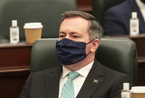 Alberta Premier Jason Kenney listens as the 2021 budget is delivered in Edmonton on Thursday, Feb. 25, 2021. Kenney says his government did not prepare a fallback plan on implementing a consumer carbon tax because they were hoping they would win in court. THE CANADIAN PRESS/Jason Franson