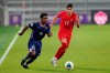 Bermuda midfielder Jahkari Furbert (15) moves the ball past Canada midfielder Theo Corbeanu (17) during the second half of a World Cup 2022 Group B qualifying soccer match, Thursday, March 25, 2021, in Orlando, Fla. THE CANADIAN PRESS/AP/John Raoux