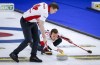 Team Canada skip Brendan Bottcher, right, makes a shot as second Brad Thiessen sweeps against Germany at the Men's World Curling Championships in Calgary, Alta., Friday, April 9, 2021.THE CANADIAN PRESS/Jeff McIntosh