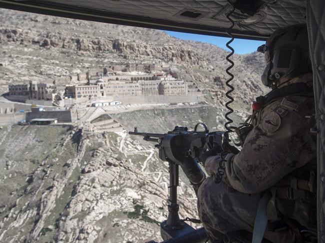 A Canadian Forces door gunner keeps watch on February 20, 2017 in northern Iraq. THE CANADIAN PRESS/Ryan Remiorz