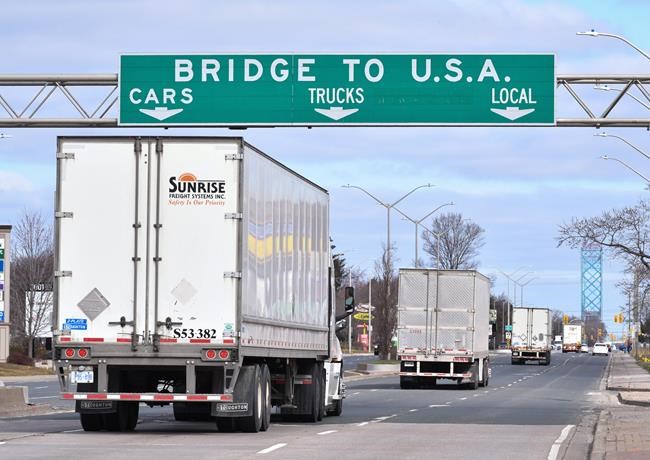Transport trucks approach the Canada/USA border crossing in Windsor, Ont. on Saturday, March 21, 2020. North American trade is facing a