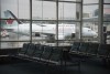 A plane is seen through the window on the tarmac of Vancouver International Airport as the waiting room is empty Tuesday, June 9, 2020. Canadians are awaiting details on Air Canada's plans for ticket refunds after the airline reached a deal for $5.9B in federal aid. THE CANADIAN PRESS/Jonathan Hayward