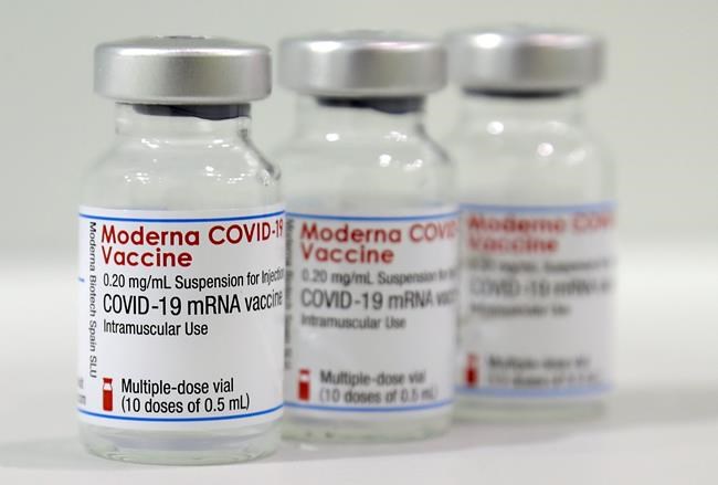 Three vials of the Moderna COVID-19 Vaccine are pictured in a new coronavirus, COVID-19, vaccination center at the Velodrome-Stadium in Berlin, Germany, Wednesday, Feb. 17, 2021. THE CANADIAN PRESS/AP/Michael Sohn, pool
