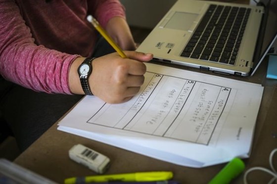 A child writes in their school notebook during a home schooling session in Cremona, Alta., Monday, March 23, 2020, amid the worldwide COVID-19 pandemic. Thousands of students in Calgary will shift to online learning as of today in a bid to curb rising COVID-19 infection rates in the city. THE CANADIAN PRESS/Jeff McIntosh