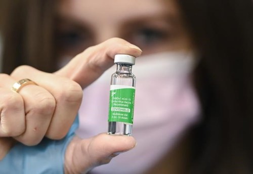 Pharmacist Barbara Violo shows off a vile of the Oxford-AstraZeneca COVID-19 vaccine at the Junction Chemist, an independent pharmacy in Toronto, Friday, March 12, 2021. A national advisory committee recommends people 30 and older can get a shot of the AstraZeneca vaccine if they do not want to wait for an mRNA alternative. THE CANADIAN PRESS/Nathan Denette