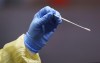 A nurse uses a swab to perform a test on a patient at a drive-in COVID-19 clinic in Montreal, on Wednesday, Oct. 21, 2020. THE CANADIAN PRESS/Paul Chiasson