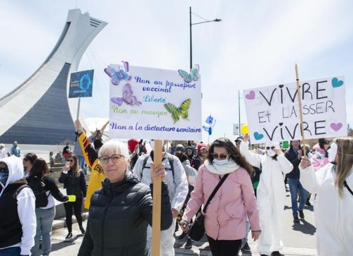 People take part in a demonstration opposing the Quebec government’s measures to help curb the spread of COVID-19 in Montreal, Saturday, May 1, 2021. THE CANADIAN PRESS/Graham Hughes