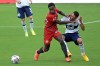 Toronto FC midfielder Richie Laryea (22) and Vancouver Whitecaps midfielder Caio Alexandre (8) compete for the ball during the second half of an MLS soccer match, Saturday, April 24, 2021, in Orlando, Fla. Unable to dig itself out of a deep first-leg hole, Toronto FC exited the Scotiabank CONCACAF Champions League on Tuesday at the hands of Cruz Azul. THE CANADIAN/AP/Phelan M. Ebenhack