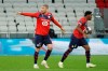 Lille's Burak Yilmaz, left, and Jonathan David, right, celebrate after they scored a goal against Lyon during their French League One soccer match in Decines, near Lyon, central France, Sunday, April 25, 2021.&nbsp; THE CANADIAN PRESS/AP-Laurent Cipriani
