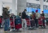 Passengers from New Delhi wait in long lines for transportation to their quarantine hotels at Pearson Airport in Toronto on Friday April 23, 2021. Transport Minister Omar Alghabra says the resumption of international travel requires a coordinated approach for testing and a common platform for recognizing the vaccinated status of travellers. THE CANADIAN PRESS/Frank Gunn