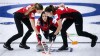 Team Canada skip Kerri Einarson, centre, makes a shot as lead Briane Meilleur, left, and second Shannon Birchard sweep against Denmark at the Women's World Curling Championship in Calgary, Alta., Thursday, May 6, 2021.THE CANADIAN PRESS/Jeff McIntosh