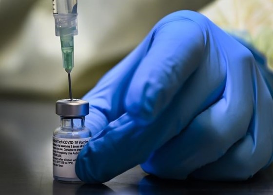 A health-care worker prepares a dose of the Pfizer-BioNTech COVID-19 vaccine at a vaccine clinic in Toronto. (Nathan Denette / The Canadian Press files)