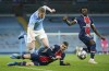 PSG's Marco Verratti, center, and PSG's Moise Kean, right, challenge Manchester City's Kevin De Bruyne during the Champions League semifinal second leg soccer match between Manchester City and Paris Saint Germain at the Etihad stadium, in Manchester, Tuesday, May 4, 2021. (AP Photo/Dave Thompson)