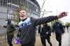 Manchester City supporters react as they walk outside the Etihad stadium in Manchester, England, Saturday, May 8, 2021 where the England Premier League match between Manchester City and Chelsea was being played. Chelsea won the match 2-1 which delayed Manchester City clinching the English Premier League title until a later date. (AP Photo/Jon Super)
