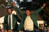 FILE - In this Sunday, April 11, 2021 file photo, Hideki Matsuyama, of Japan, puts on the champion's green jacket after winning the Masters golf tournament as Dustin Johnson watches in Augusta, Ga. Matsuyama already is thinking about what to serve at the champions dinner next April. It likely will include sushi. (AP Photo/David J. Phillip, File)