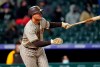 San Diego Padres' Manny Machado watches his three-run triple off Colorado Rockies relief pitcher Tyler Kinley during the sixth inning of a baseball game Tuesday, May 11, 2021, in Denver. (AP Photo/David Zalubowski)