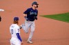 Seattle Mariners' Mitch Haniger, right, heads to third after hitting a solo home run as Los Angeles Dodgers third baseman Justin Turner watches during the first inning of an interleague baseball game Tuesday, May 11, 2021, in Los Angeles. (AP Photo/Mark J. Terrill)
