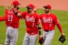 Cincinnati Reds' Eugenio Suarez (7) celebrates as he walks off the field with Nick Castellanos (2) after getting the final out of a baseball game against the Pittsburgh Pirates in Pittsburgh, Wednesday, May 12, 2021. The Reds won 5-1.(AP Photo/Gene J. Puskar)