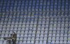 A TV cameraman wears a face mask sets up his camera before the start of the English Premier League soccer match between Chelsea and Fulham at Stamford Bridge Stadium in London, Saturday, May 1, 2021. (Justin Setterfield/Pool via AP)