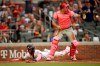 Atlanta Braves' Ronald Acuna Jr. slides safe to score as Philadelphia Phillies catcher J.T. Realmuto waits for the ball in the first inning of a baseball game Sunday, May 9, 2021, in Atlanta. Acuna scored on a single by Braves' Freddie Freeman. (AP Photo/Ben Margot)