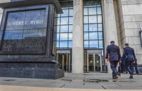 FILE - In this May 3, 2021, file photo, Huntington Mayor Steve Williams, left, and lawyer Rusty Webb enter the Robert C. Byrd United States Courthouse in Charleston, W. Va., for the start of the opioid trial. Local governments seeking to hold companies accountable for the opioid crisis in the U.S. are finally getting their day in court in West Virginia and California. The outcome could lead to broader settlements involving some opioid makers and distributors. (Kenny Kemp/Charleston Gazette-Mail via AP, File)