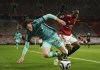 Liverpool's Andrew Robertson, left, duels for the ball with Manchester United's Aaron Wan-Bissaka during the English Premier League soccer match between Manchester United and Liverpool, at the Old Trafford stadium in Manchester, England, Thursday, May 13, 2021. (AP Photo/Dave Thompson, Pool)