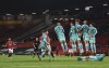 Liverpool's defensive wall blocks a free kick of Manchester United's Bruno Fernandes during the English Premier League soccer match between Manchester United and Liverpool, at the Old Trafford stadium in Manchester, England, Thursday, May 13, 2021. (Michael Regan/Pool via AP)
