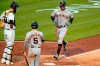 San Francisco Giants' Mike Tauchman, right, scores on an errant pickoff throw to third base by Pittsburgh Pirates catcher Jacob Stallings, left, during the fifth inning of a baseball game in Pittsburgh, Thursday, May 13, 2021.(AP Photo/Gene J. Puskar)