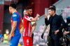 Atletico Madrid's head coach Diego Simeone, right, speaks with his player Koke during a water break during the Spanish La Liga soccer match between FC Barcelona and Atletico Madrid at the Camp Nou stadium in Barcelona, Spain, Saturday, May 8, 2021. (AP Photo/Joan Monfort)