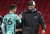 Liverpool's manager Jurgen Klopp, right, shakes hands with Liverpool's Andrew Robertson at the end of the English Premier League soccer match between Manchester United and Liverpool, at the Old Trafford stadium in Manchester, England, Thursday, May 13, 2021. (Michael Regan/Pool via AP)