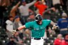Seattle Mariners' Jarred Kelenic reacts to the home run of Mitch Haniger as he heads in to score against the Cleveland Indians during the seventh inning of a baseball game Friday, May 14, 2021, in Seattle. (AP Photo/Elaine Thompson)