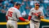 Washington Nationals' Trea Turner, right, is congratulated by third base coach Bob Henley after hitting a home run against the Arizona Diamondbacks during the first inning of a baseball game Friday, May 14, 2021, in Phoenix. (AP Photo/Darryl Webb)