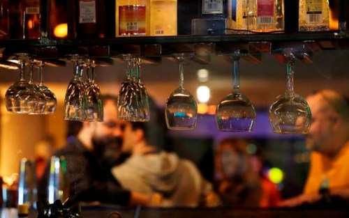 People gather and celebrate as bars, clubs and other establishments reopened in Poland after being closed for seven months, in Warsaw, Poland, Friday, May 14, 2021. (AP Photo/Czarek Sokolowski)