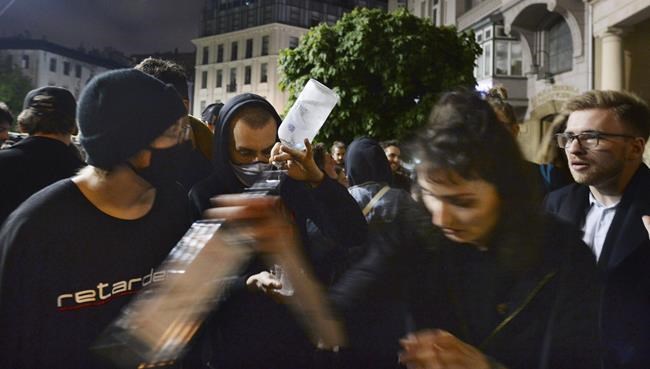 People gather and celebrate as bars, clubs and other establishments reopened in Poland after being closed for seven months, in Warsaw, Poland, Friday, May 14, 2021. (AP Photo/Czarek Sokolowski)