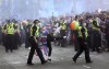 Police and Rangers fans face off outside the soccer ground before the Scottish Premiership soccer match against Aberdeen at Ibrox Stadium in Glasgow, Saturday May 15, 2021. Rangers on Saturday will lift their first Scottish Premiership trophy in a decade. (Robert Perry/PA via AP)