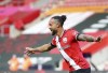 Southampton's Theo Walcott celebrates after scoring his side's third goal during the English Premier League soccer match between Southampton and Fulham at St. Mary's Stadium in Southampton, England, Saturday, May 15, 2021. (Peter Cziborra/Pool via AP)