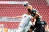 Augsburg's Florian Niederlechner, left, and Werder Bremen's Omer Toprak challenge for the ball during the German Bundesliga soccer match between FC Augsburg and SV Werder Bremen in Augsburg, Germany, Saturday, May 15, 2021. (Matthias Balk/dpa via AP)