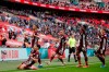 Leicester's Youri Tielemans, left, standing, celebrates after scoring the opening goal during the FA Cup final soccer match between Chelsea and Leicester City at Wembley Stadium in London, England, Saturday, May 15, 2021. (Matt Childs/Pool via AP)