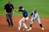 Tampa Bay Rays' Joey Wendle, center reaches second base with a double ahead of the tag by New York Mets shortstop Francisco Lindor, right, during the seventh inning of a baseball game Saturday, May 15, 2021, in St. Petersburg, Fla. Looking on is umpire Brian Knight(AP Photo/Chris O'Meara)