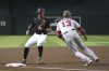 Arizona Diamondbacks' David Peralta beats the throw in front of Washington Nationals third baseman Starlin Castro (13), advancing on a single by Daulton Varsho the first inning during a baseball game Saturday, May 15, 2021, in Phoenix. (AP Photo/Rick Scuteri)