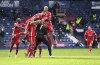 Liverpool's goalkeeper Alisson celebrates with teammates after scoring his side's second goal during the English Premier League soccer match between West Bromwich Albion and Liverpool at the Hawthorns stadium in West Bromwich, England, Sunday, May 16, 2021. (Laurence Griffiths/Pool via AP)