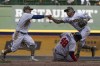 Milwaukee Brewers' Kolten Wong and Luis Urias fumble the ball as Atlanta Braves' Pablo Sandoval slides safely into second during the seventh inning of a baseball game Sunday, May 16, 2021, in Milwaukee. (AP Photo/Morry Gash)